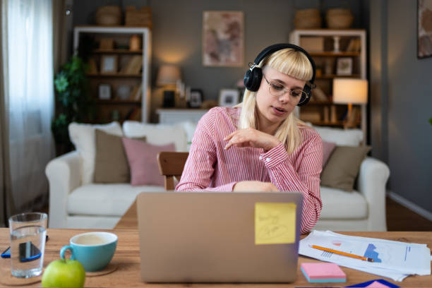 istock Young freelance businesswoman attending online educational class on laptop computer webcam teleconference in progress watching and listening educator expert about economy and finance. Online business 2147701609