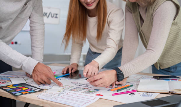 istock Creative team of designers in application design and ux/ui usability planning. Modern business team teamwork. 2147701866