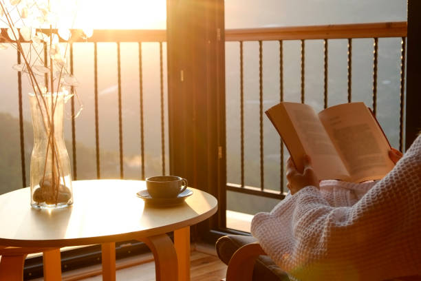istock Woman reading in cozy room. 2147702842