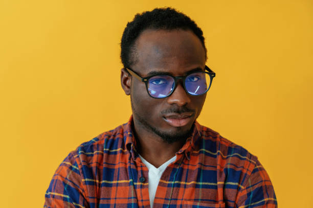 istock Standing and posing. Black man is in the studio against yellow background 2147703276