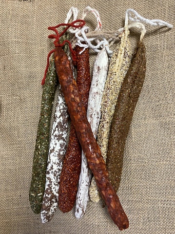 Assortment of fuets and chorizo on sackcloth. Traditional sausage from Catalonia.