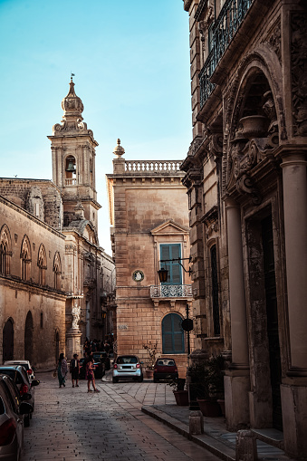 Streets Engulfed In The Shadows Of Carmelite Church Clocktower In Mdina, Malta