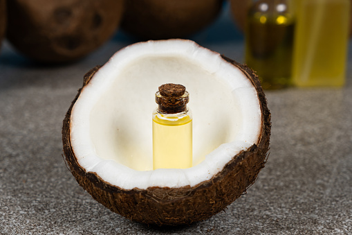 Coconut oil in a small glass bottle for skin and hair care