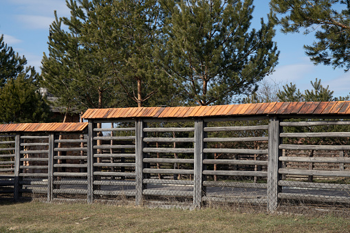 Wooden horizontal planked fence on the residental territory