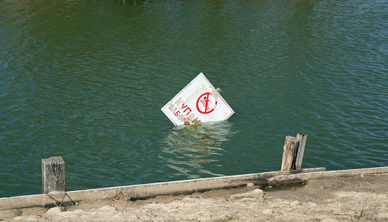 No swimming allowed sign in the lake water