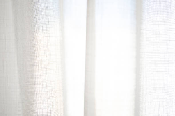 istock White transparent curtain with sunlight close up 2147704911