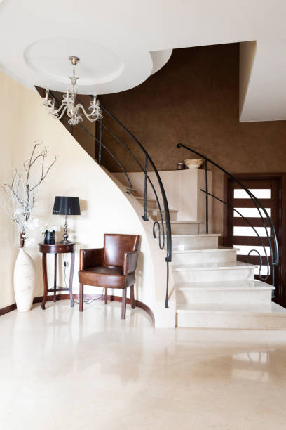 istock Home interior in modern corridor with marbled effect and elegance design. Staircase from stone material in residential building. Vertical. 2147705038