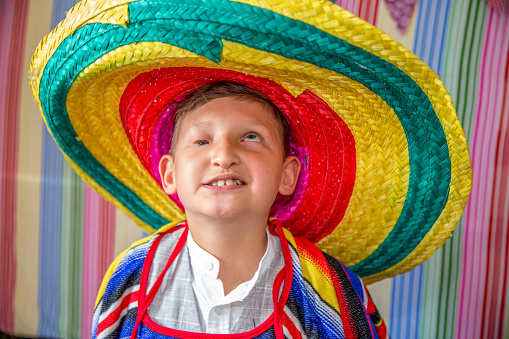 Partially blind disabled boy in sombrero