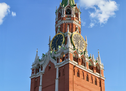 Red Square. Spasskaya tower with a clock on a background of blue sky. Vertical. Moscow, Russia