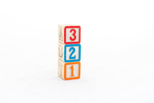 istock Stacked wooden cubes with numbers three, two and one isolated on white background 2147707097