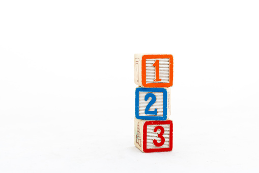 One, two and three number blocks stacked on each other isolated on white background