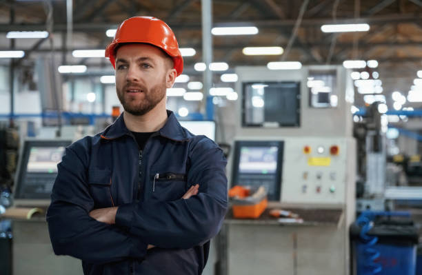 istock Confident facial expression. Factory worker is indoors with hard hat 2147709371