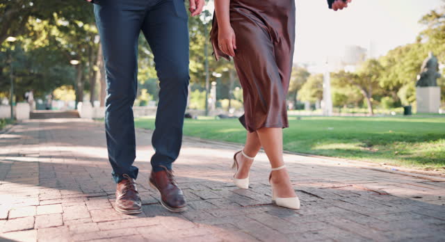 Couple, feet and walking to date, path and nature in park, elegant and closeup up on legs and shoes. Outdoor, person and partner with romance on road, love and peace to relax in relationship