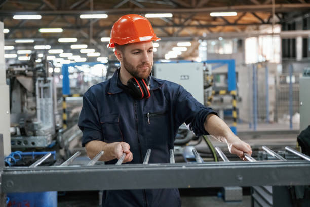istock Industrial line, working. Factory worker is indoors with hard hat 2147709722
