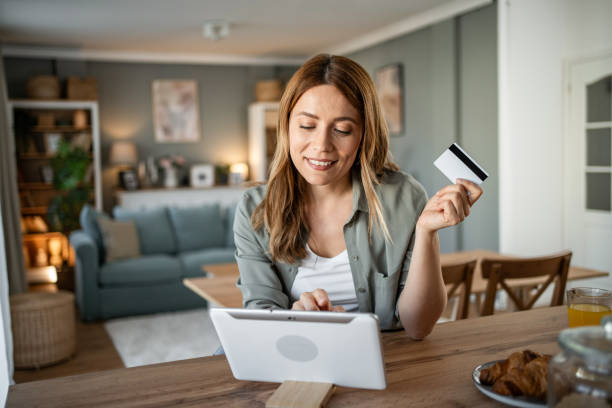 istock A woman is sitting in her room checking her monthly budget via internet banking, using a digital tablet and credit card 2147710179