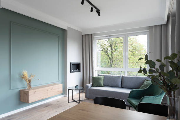 istock Comfortable sofa in living room with decor green wall. Home interior. 2147710200