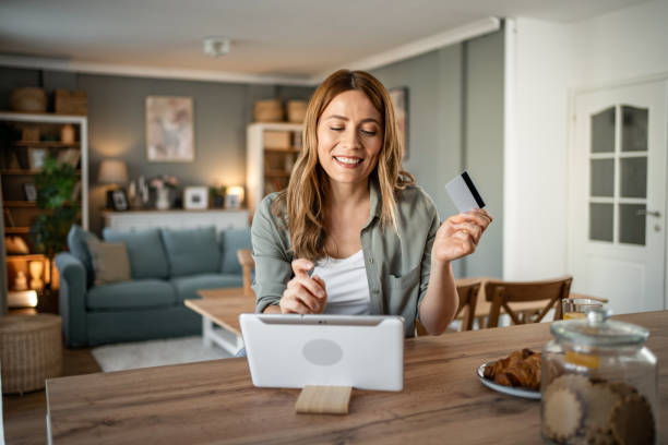 istock A woman is sitting in her room checking her monthly budget via internet banking, using a digital tablet and credit card 2147710330