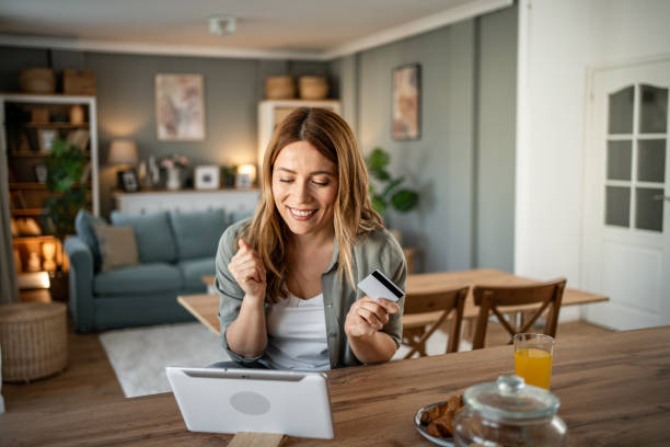 istock A woman is sitting in her room checking her monthly budget via internet banking, using a digital tablet and credit card 2147710331