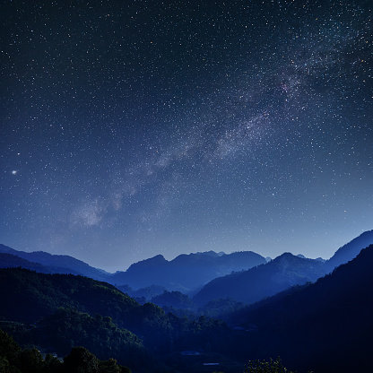 Beautiful landscape blue mountains at the night with Milky Way background, Chiang mai , Thailand