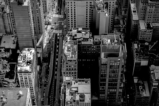 High angle street photography of New York City.  This is on a bright spring day and features the varied roof tops of smaller apartment blocks and buildings.