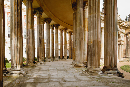 Ancient colonnade, with the rhythmic alignment of weathered columns adorned with intricate designs