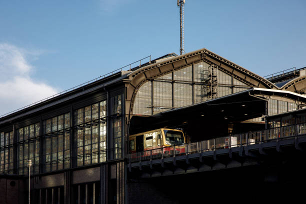 Railway station in a city built in impressionist style. The train on the platform