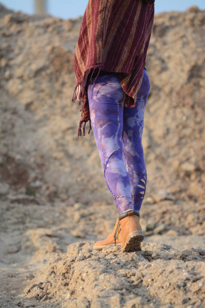 istock Walking in the sand, wearing purple cut out leggings 2147711035