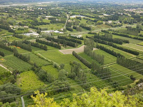 Photo of an aerial view of countless fields which extend over the verdant valley of the Durance. This nature photograph was taken in the Alpilles in Provence in France.