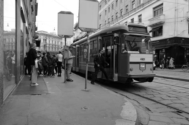 Milan, Italy - April 09, 2024:  people use the tram in the center of Milan