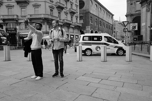 Milan, Italy - April 09, 2024: people take photo in the center of city