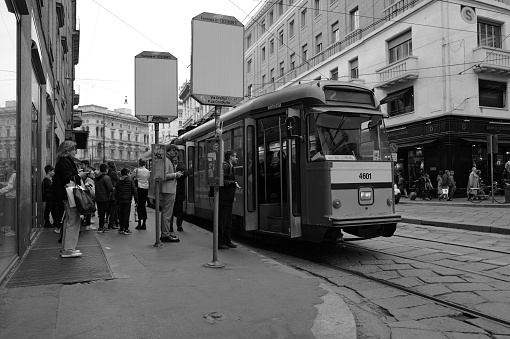 Milan, Italy - April 09, 2024:  people use the tram in the center of Milan