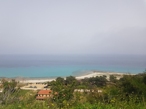 The view of the beach during a day with African dust in the atmosphere