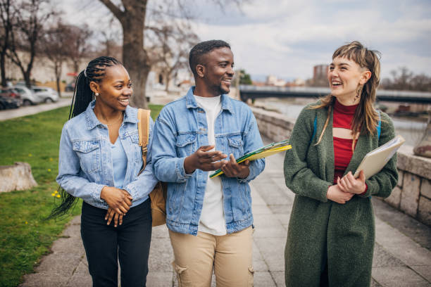 istock Smiling students walking and chatting outdoors 2147714987