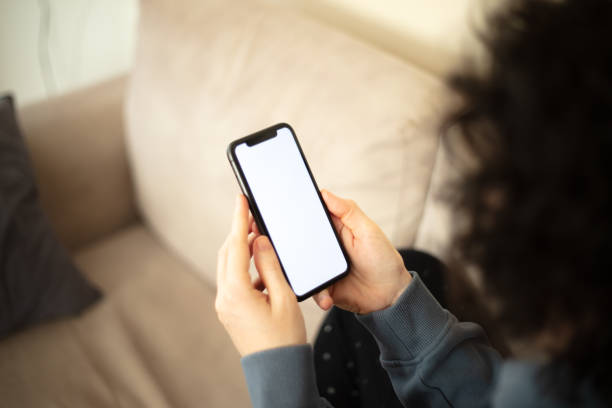 istock A woman is looking her mobile phones white screen. 2147715475