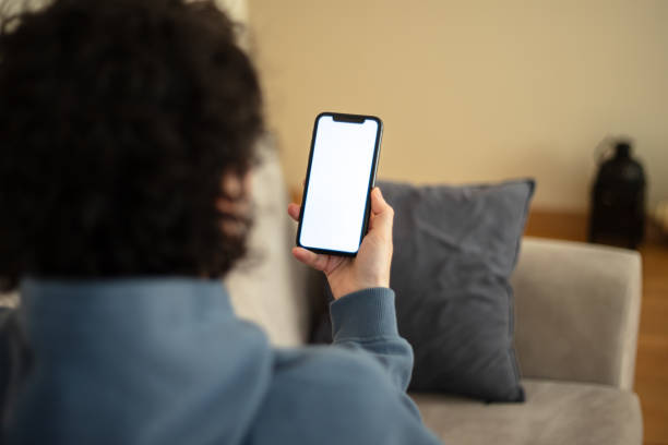 istock A woman is looking her mobile phones white screen. 2147715524