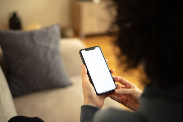 istock A woman is looking her mobile phones white screen. 2147715537