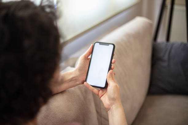 istock A woman is looking her mobile phones white screen. 2147715744