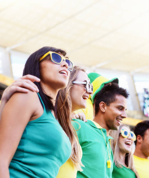 istock Sports fans: happy soccer supporters in the crowd at a stadium 2147715853