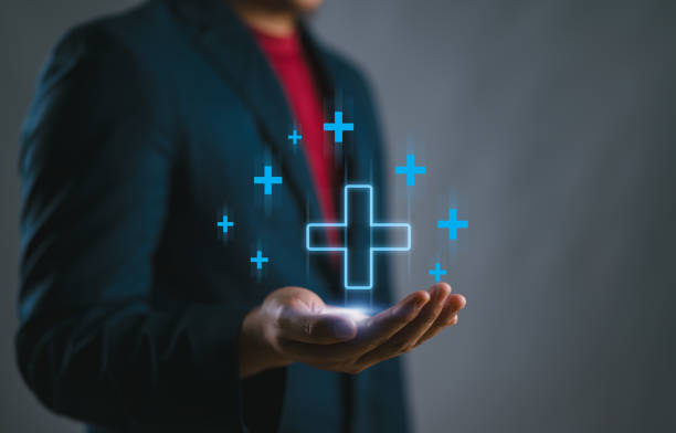 istock Businessman interacting with a blue plus sign, representing a mindset of positivity, mental health care, and insurance in mental rejuvenation, positive thinking mindset. Good, best. 2147715902