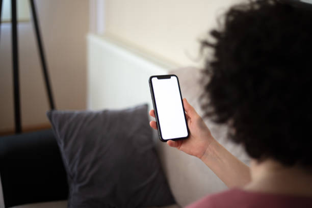 istock A woman is looking her mobile phones white screen. 2147715997