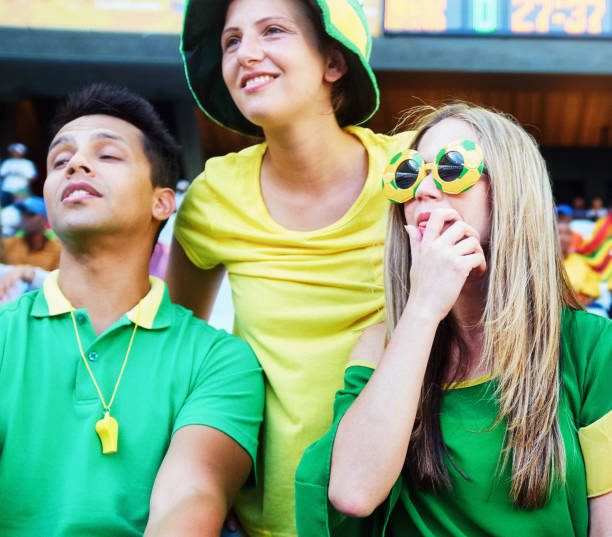 istock Sports fans: confused soccer supporters react in the crowd at a stadium 2147716098