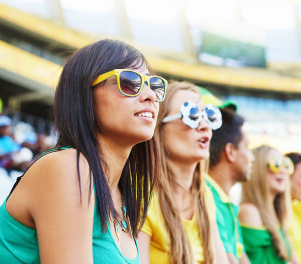 istock Sports fans: soccer supporters in the crowd at a stadium 2147716159