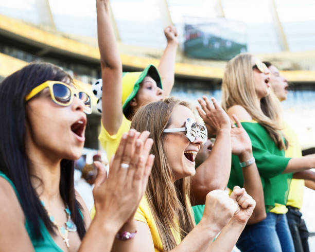 istock Sports fans: soccer supporters cheering in the crowd at a stadium 2147716197
