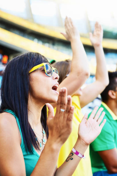 istock Sports fans: cheering soccer supporters in the crowd at a stadium 2147716286