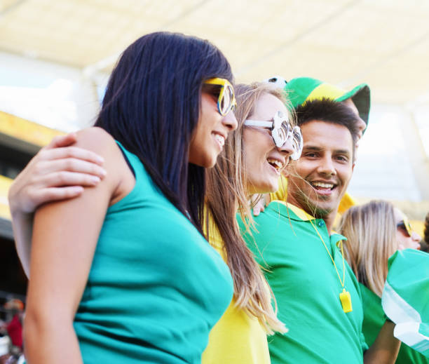 istock Sports fans: happy soccer supporters in the crowd at a stadium 2147716322
