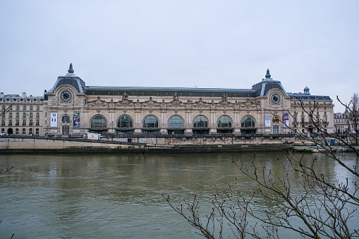 Paris, France - 21.02.2024. Musée d'Orsay art museum in Paris view from Seine riverside. Orsay museum. The landmark Musée d'Orsay, an art museum housed in the historic former Gare d'Orsay train station, sits on the River Seine.