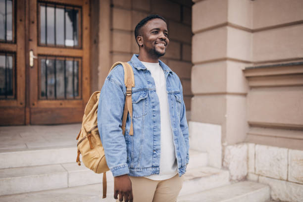istock Smiling college student with backpack outdoors 2147717538