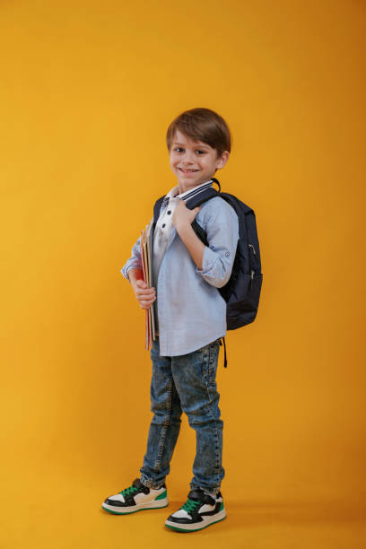 istock Little boy is in the studio against yellow background 2147717776