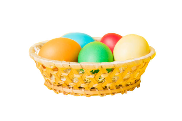 Basket of colorful Easter eggs isolated on white background. Easter basket filled with colored eggs top view holiday concept .