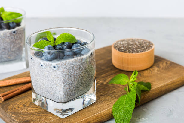 istock Healthy breakfast or morning with chia seeds vanilla pudding and blueberry berries on table background, vegetarian food, diet and health concept. Chia pudding with coconut milk and blueberry 2147718452